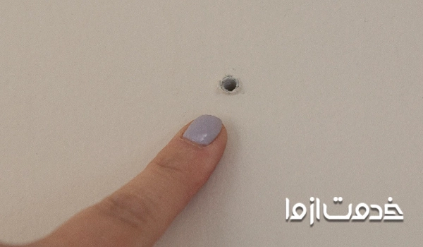 پوشاندن جای میخ روی دیوار